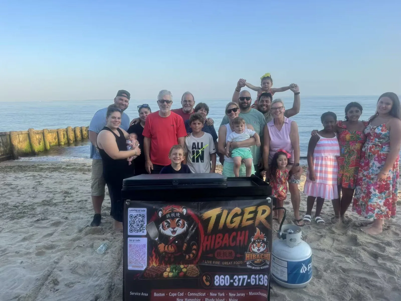 Large family group photographed with the Tiger Hibachi griddle at a Connecticut shoreline beach party